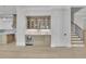Open-concept living area featuring built-in cabinets and stylish lighting, with hardwood floors at 123 Candler Loop, Acworth, GA 30101
