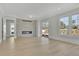 Bright living room with hardwood floors, fireplace, sliding glass doors, and large windows at 123 Candler Loop, Acworth, GA 30101