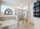Modern bathroom featuring a tub, shower, and stylish towel rack for storage at 142 Richmond Way, Villa Rica, GA 30180
