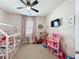 Playful room featuring a bed frame, toys, and pink curtains at 142 Richmond Way, Villa Rica, GA 30180