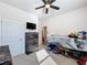 Bright bedroom with ceiling fan, a dresser, a TV, an entry door, and ample space at 142 Richmond Way, Villa Rica, GA 30180