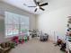 Playful bedroom with ceiling fan, large window, and space for creative activities at 142 Richmond Way, Villa Rica, GA 30180
