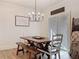 Cozy dining area with a farmhouse table, bench seating, and natural light from sliding doors at 142 Richmond Way, Villa Rica, GA 30180