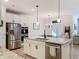 Modern kitchen with granite countertops, stainless steel appliances, and ample cabinet space at 142 Richmond Way, Villa Rica, GA 30180