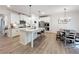 Well-lit kitchen featuring a granite island, white cabinets, and stainless steel appliances at 142 Richmond Way, Villa Rica, GA 30180