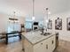 Open-concept kitchen featuring a granite island, dining area, and view of the living room at 142 Richmond Way, Villa Rica, GA 30180