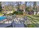 Spacious backyard with a large wooden deck, an inground pool and a storage shed surrounded by mature trees at 1566 Arden Sw Dr, Marietta, GA 30008