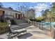 Brick home featuring a sprawling deck with seating, an inground pool, and lush landscaping in the backyard at 1566 Arden Sw Dr, Marietta, GA 30008