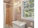 Cozy bathroom features a white sink, shower and tub combination, and a window at 1566 Arden Sw Dr, Marietta, GA 30008