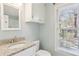 Light and airy bathroom with granite countertop vanity, toilet, and a window for natural light at 1566 Arden Sw Dr, Marietta, GA 30008