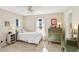 Cozy bedroom features neutral walls, two windows for natural light, and an antique green dresser at 1566 Arden Sw Dr, Marietta, GA 30008