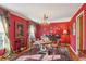 Red dining room featuring a round table, chandelier, and ample natural light at 1566 Arden Sw Dr, Marietta, GA 30008