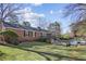 Beautiful brick home with a well-manicured lawn, a large backyard deck, and an inground swimming pool at 1566 Arden Sw Dr, Marietta, GA 30008