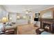 Cozy living room with a fireplace, built-in shelves, and hardwood floors at 1566 Arden Sw Dr, Marietta, GA 30008