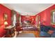 Bright red living room with elegant furniture, hardwood floors and decor at 1566 Arden Sw Dr, Marietta, GA 30008