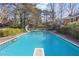 Refreshing inground swimming pool with a diving board and slide, surrounded by a spacious green backyard at 1566 Arden Sw Dr, Marietta, GA 30008