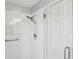 Modern shower with glass door, white subway tile, and sleek shower head at 1566 Arden Sw Dr, Marietta, GA 30008