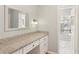 Bathroom vanity area with granite countertop, drawers and cabinet space, with a large mirror at 1566 Arden Sw Dr, Marietta, GA 30008