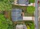 An aerial view of the brick home with a dark roof surrounded by lush greenery at 2121 Whitekirk Nw St, Kennesaw, GA 30152