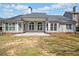 Gray home exterior showcases arched windows and a large patio area with partial grass at 2121 Whitekirk Nw St, Kennesaw, GA 30152