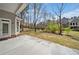Picture of the backyard with a gray home exterior and neighboring properties, trees and green grass at 2121 Whitekirk Nw St, Kennesaw, GA 30152