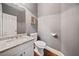 Small bathroom with white toilet, vanity, granite countertop and picture frame on a grey wall at 2121 Whitekirk Nw St, Kennesaw, GA 30152