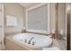 Bathroom showcasing soaking tub, tiled surround and a separate shower at 2121 Whitekirk Nw St, Kennesaw, GA 30152