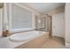 Bathroom showcasing soaking tub, tiled surround and a separate shower at 2121 Whitekirk Nw St, Kennesaw, GA 30152