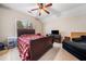 Bedroom with a queen bed with plaid comforter, flat screen tv, and black chaise lounge at 2121 Whitekirk Nw St, Kennesaw, GA 30152