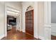 Inviting foyer featuring a decorative front door, hardwood floors, and an open view into the living spaces at 2121 Whitekirk Nw St, Kennesaw, GA 30152