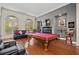 Spacious game room with a pool table, hardwood floors, and comfortable seating at 2121 Whitekirk Nw St, Kennesaw, GA 30152