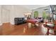 Open-concept game room featuring a pool table, hardwood floors, and comfortable leather seating at 2121 Whitekirk Nw St, Kennesaw, GA 30152