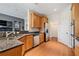 Kitchen with granite countertops, stainless steel appliances, wooden cabinets, and hardwood floors at 2121 Whitekirk Nw St, Kennesaw, GA 30152