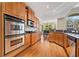 Gourmet kitchen boasts stainless appliances, granite countertops and wooden cabinets at 2121 Whitekirk Nw St, Kennesaw, GA 30152