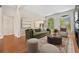 Staged living room with large arched windows, modern furniture and access to an adjacent living space at 2121 Whitekirk Nw St, Kennesaw, GA 30152