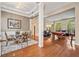 Elegant living room with hardwood floors, large windows, a dining area, and a pool table for entertaining guests at 2121 Whitekirk Nw St, Kennesaw, GA 30152