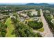 Scenic aerial view of neighborhood featuring a golf course, ponds, and roads at 2121 Whitekirk Nw St, Kennesaw, GA 30152