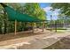 Community playground with swings and play structures under a shaded canopy at 2121 Whitekirk Nw St, Kennesaw, GA 30152