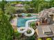 Community pool with a slide, sun deck, and chairs, perfect for relaxation at 2121 Whitekirk Nw St, Kennesaw, GA 30152
