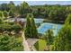 Aerial view of multiple community tennis courts surrounded by lush trees at 2121 Whitekirk Nw St, Kennesaw, GA 30152
