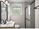 Updated bathroom featuring a shower with glass doors, modern vanity, and stylish fixtures at 3069 Thrasher Cir, Decatur, GA 30032