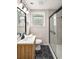 Updated bathroom with black tile floor, a shower with glass doors, modern vanity, and stylish fixtures at 3069 Thrasher Cir, Decatur, GA 30032