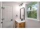 Updated bathroom features a wood vanity, brushed nickel fixtures, and a window with a view at 3069 Thrasher Cir, Decatur, GA 30032