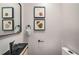 Modern powder room with black sink, fixtures, light wood cabinet, and framed art at 3069 Thrasher Cir, Decatur, GA 30032