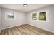 Neutral bedroom features wood floors, white trim, and two windows offering natural light at 3069 Thrasher Cir, Decatur, GA 30032