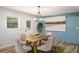 Elegant dining room with modern lighting, stylish decor, and a view to the backyard at 3069 Thrasher Cir, Decatur, GA 30032