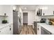 Well-lit kitchen features white cabinets, stainless appliances, and modern backsplash and leads to the hallway at 3069 Thrasher Cir, Decatur, GA 30032