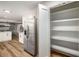 Open kitchen with stainless steel appliances, white cabinets, and a large pantry for storage at 3069 Thrasher Cir, Decatur, GA 30032