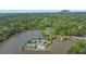 Aerial view of community amenities: lake, tennis courts, swimming pool, and lush greenery at 7037 Waters Edge Dr, Stone Mountain, GA 30087