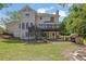 A spacious backyard features a large deck, a stone patio, and lush greenery, perfect for outdoor enjoyment at 7037 Waters Edge Dr, Stone Mountain, GA 30087